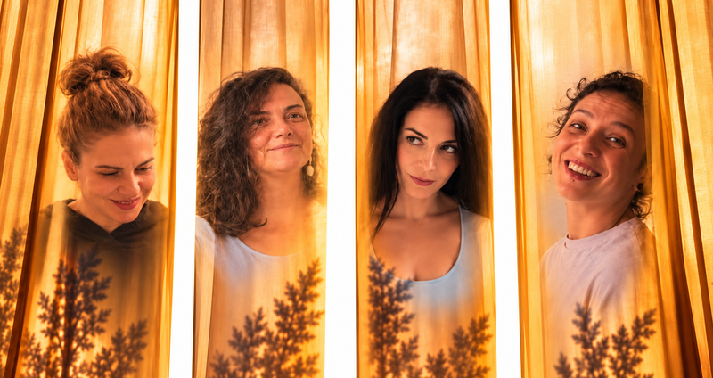 Four_women_behind_golden_curtains.2e16d0ba.fill-1375x729.png